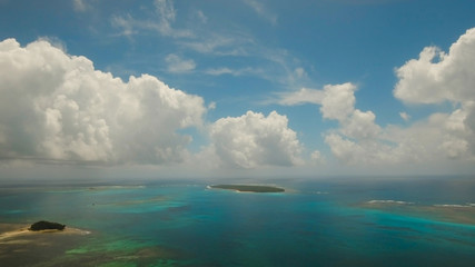 Aerial view of beautiful tropical island Daco with white sand beach. View of a nice tropical beach from the air. Beautiful sky, sea, resort. Seascape: Ocean and beautiful beach paradise. Philippines.