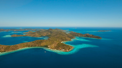 Fototapeta na wymiar Aerial view: Lagoon with blue, azure water in the middle of small islands and rocks, Palawan. Beach, tropical island, sea bay and lagoon, mountains with forest, Coron. Busuanga. Seascape, tropical