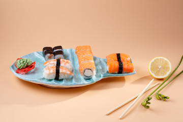 rolls and sushi on a plate in the form of fish