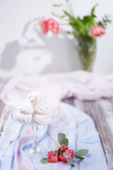 marshmallows in a glass stand on a blue fabric