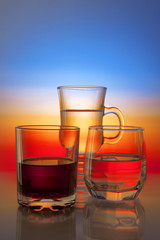 Glasses with drinks on beautiful gradient background