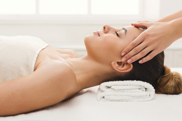 Obraz na płótnie Canvas Woman getting professional facial massage at spa salon