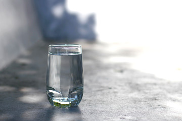 one water glass with blur background and sun light