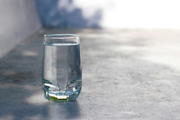 one water glass with blur background and sun light