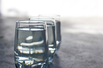 row of water glass with blur background