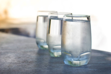 row of ice water glass with blur background