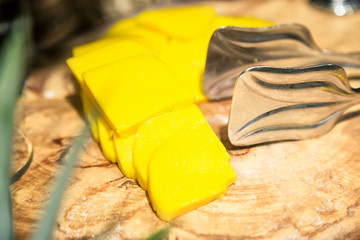 Yellow cheese on wooden board