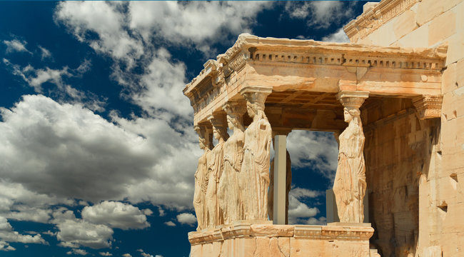 caryatids in Athens Greece sky clouds