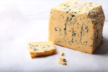 Mature Blue Stilton cheese on light background