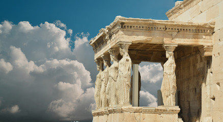 caryatids in Athens Greece sky clouds