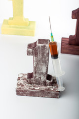 three figures one next to the one leaning against the syringe with the dope