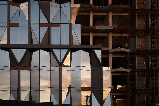 Partially constructed building reflecting the sunset