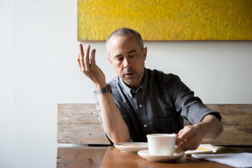 Man having breakfast and writing