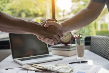 Business people Handshake (shaking hands) with partnership over office desk,business man and woman greeting,successful after signing contract and dealing.Negotiation,deal business concept