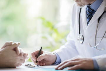 Doctor and patient taking notes in surgery