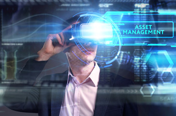 Business, Technology, Internet and network concept. Young businessman working on a virtual screen of the future and sees the inscription: Asset management