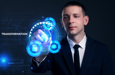Business, Technology, Internet and network concept. Young businessman working on a virtual screen of the future and sees the inscription: Transformation