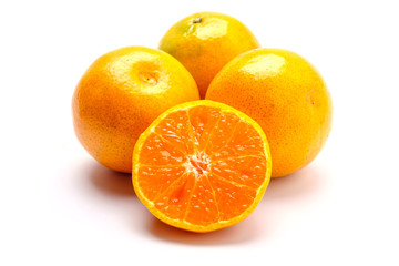 Fresh orange cut in half on a white background.