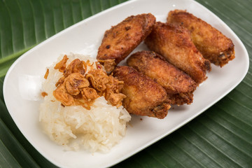 Sticky Rice and Fried chicken in plate on banana leaf