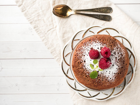 Chocolate pancakes with powdered sugar raspberry. Copy space