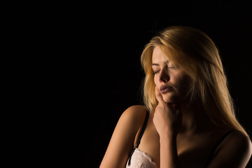 Closeup portrait of sensual young lady in pink lace bra in the shadow. Space for text