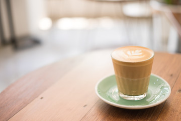 latte art on wooden table ,seletive focus with extremly shallow depth of field