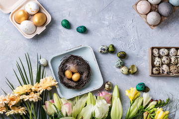 Easter decoration with colored quail and chicken eggs