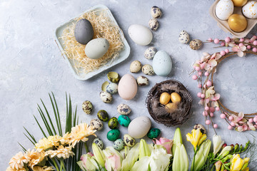 Easter decoration with colored quail and chicken eggs