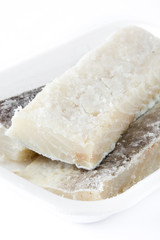 Salted dried cod isolated on white background. Typical Easter food
