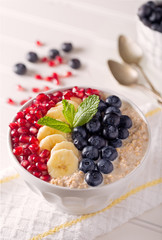 Steel Cut Oats with Pomegranage Seed, Banana, and Blueberries with a Sprig of Mint