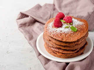 Chocolate pancakes with powdered sugar raspberry. Copy space