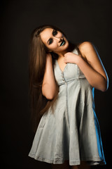 Magnificent young woman with long hair and creative metallic makeup