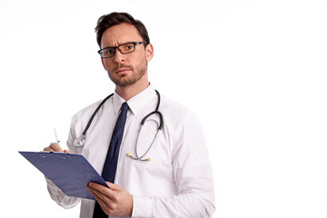smart handsome bearded medical doctor in glasses with Stethoscope isolated on white background. Man from hospital with a Clipboard is ready to write something down