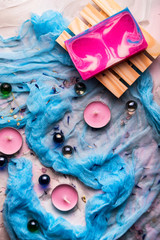 Romantic background with candles, soap and shawl