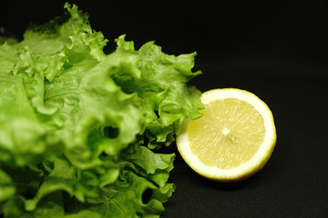 lettuce and lemon on black background