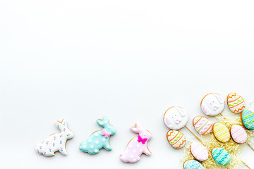 Sweets, pastry for Easter table. Easter eggs and Easter bunny concept. White background top view space for text