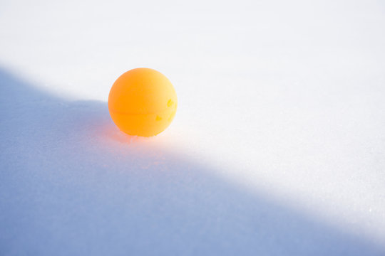 Ping Pong Ball On The Snow. Table Tennis, Also Known As Ping Pong, Is A Sport In Which Two Or Four Players Hit A Lightweight Ball Back And Forth Across A Table Using Small Bats