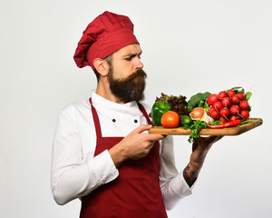 Portrait of a smiling chef cook holding vegetables