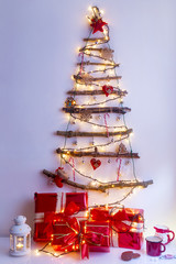 Christmas tree made of dry branches with lights and ornaments