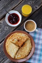 Fresh pancakes with strawberry jam, coffee and juice 