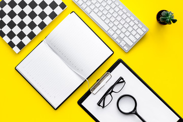 Strict work desk of accutate person and productive worker. Geometrical pattern. Yellow background top view mockup
