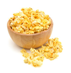 fresh popped popcorn isolated in wooden bowl on white background