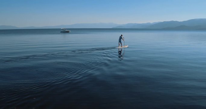 4k Breathtaking view of lone stand up paddle boarder on Lake Tahoe,