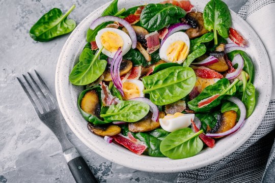 Lunch Bowl Of Spinach Salad With Bacon, Mushrooms, Eggs And Red Onions