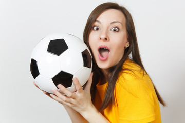 Close up pretty European young smiling happy woman, football fan or player in yellow uniform holding soccer ball isolated on white background. Sport, play football, health, healthy lifestyle concept.