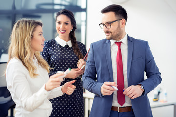 Group of business people discussing the latest details about the project in the office