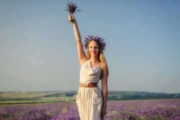 Charming girl in lavender field posing as Statue of Liberty, cheerful emotion