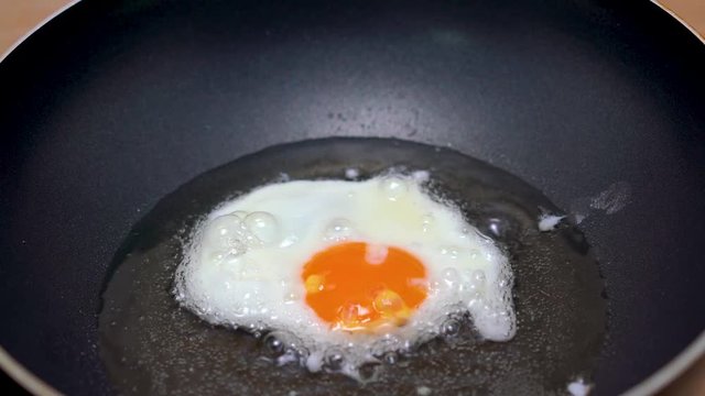 Fried egg. Egg cooks on frying pan. Time-lapse.
