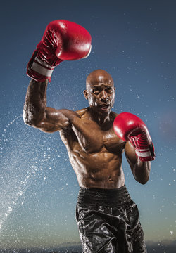 Water splashing on man boxing