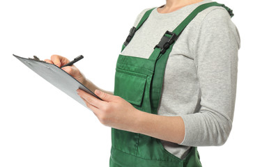 Female auto mechanic with clipboard and pen on white background, closeup